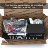 Overview of Maker Kit with hammer, stamps, instruction pamphlet, and tokens