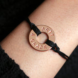 Woman wearing bracelet with a Token that says "Grit & Grace"