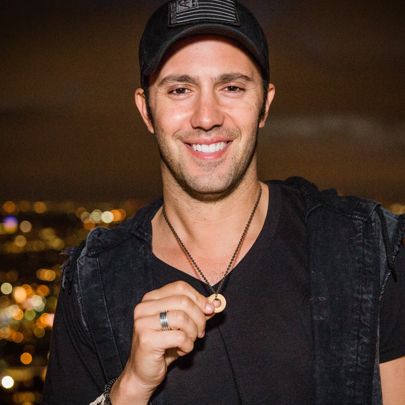 Man wearing MyIntent token necklace