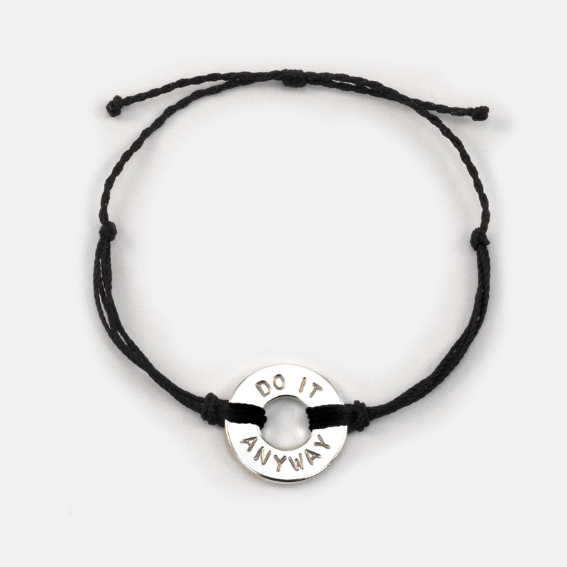Mel Robbins' signature Twist Bracelet Black String Silver Token with the words DO IT ANYWAY