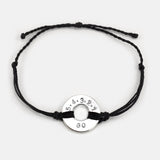 Mel Robbins' signature Twist Bracelet Black String Silver Token with the message 5.4.3.2.1.GO!
