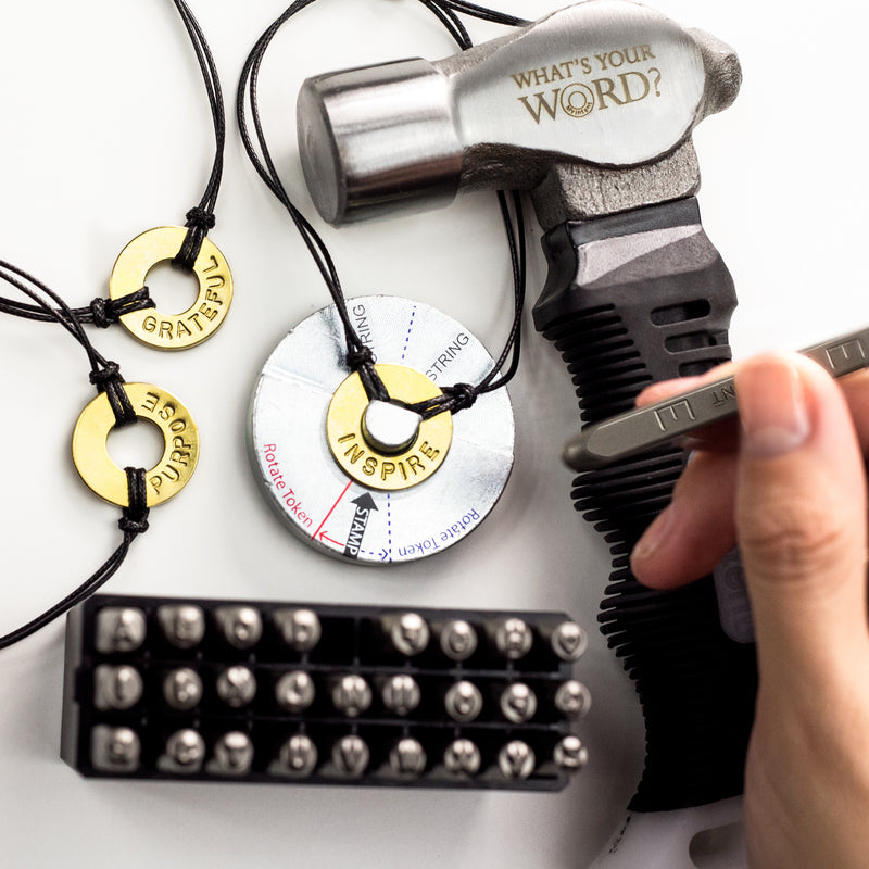 Someone Stamping INSPIRE on a Bracelet using MyIntent Maker Kit